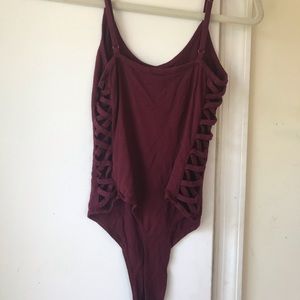 Maroon bodysuit with crisscross detailing on side